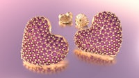 a pair of heart shaped earrings with pink stones